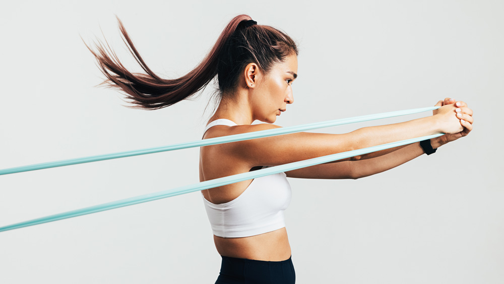 Sportswoman exercising with resistance band